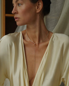 Editorial of model in cream silk wrap top wearing Lera Treyger x Anouk Yve sterling silver collar with chain drop