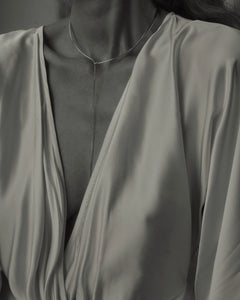 B&W of model in champagne silk wrap dress wearing Lera Treyger x Anouk Yve silver collar necklace