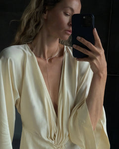 Mirror selfie of blonde model in cream silk dress wearing Lera Treyger x Anouk Yve silver collar with drop chain