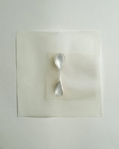 Lera Treyger LOBBY sterling silver baby spoon photographed top-down on layered translucent vellum papers, editorial still life