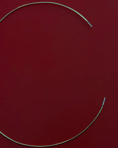 Studio still life of Lera Treyger Earth 14k gold diamond choker necklace on deep red leather background
