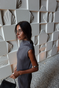 Lera Treyger LT x O.RIM sterling silver cuff in editorial styling, gray pleated dress, architectural background
