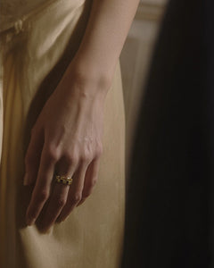 Ukiyo n 1 yellow gold diamond eternity ring styled on hand against silk slip dress in warm light