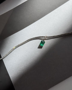 Lera Treyger Ukiyo n 3 white gold diamond tennis bracelet with emerald-cut emerald, dramatic light still life on silver paper