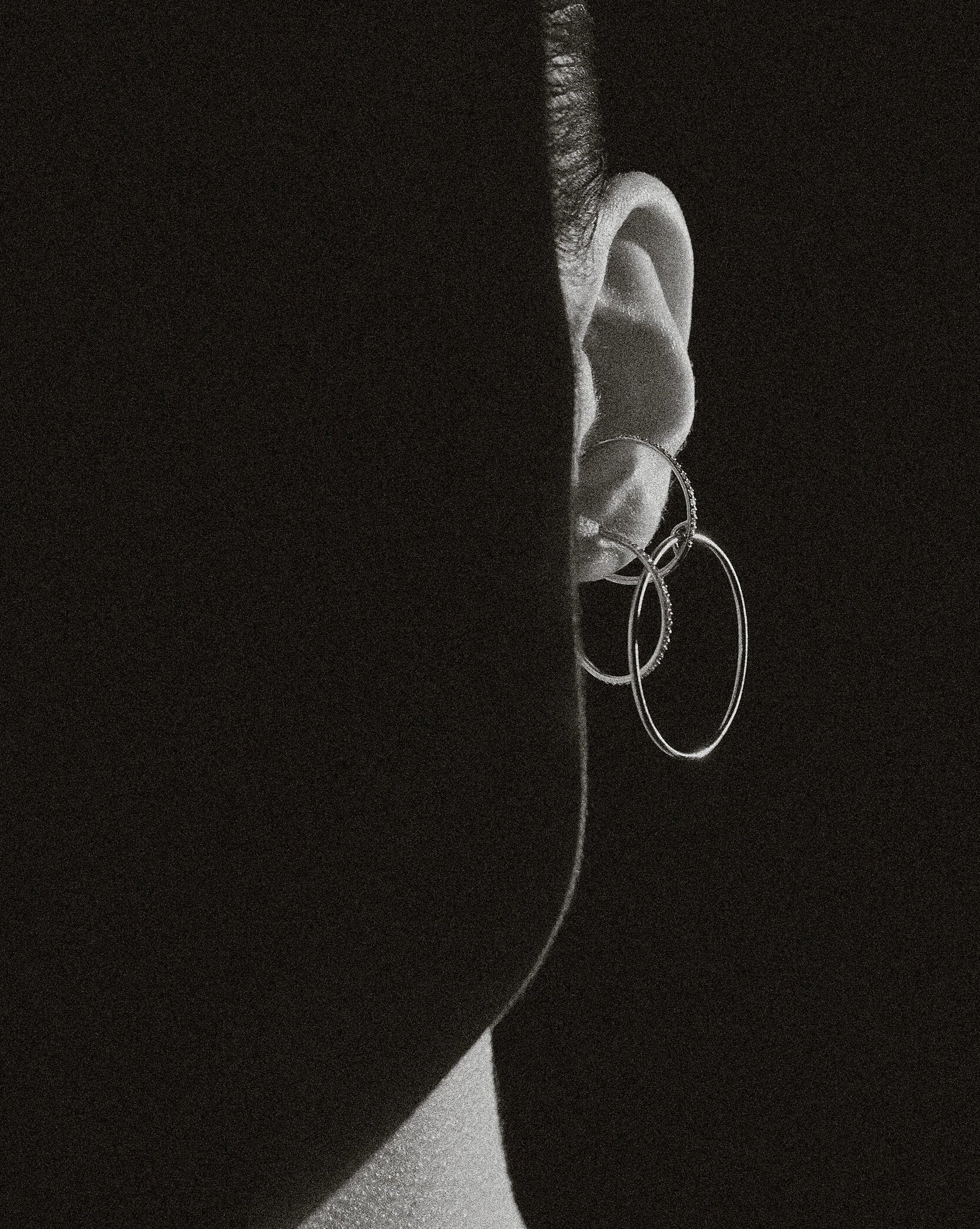B&W ear macro of Lera Treyger Wind interlocked diamond and plain hoop ear cuff, dramatic side light